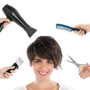 Happy smiling young woman with hairdresser tools among her isolated on white background.