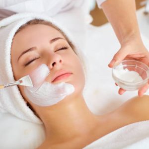 Woman in mask on face in spa beauty salon. Woman in mask on face in spa beauty salon.